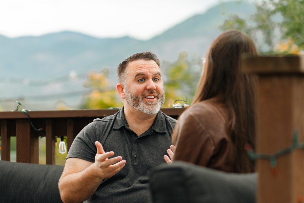 Caleb discussing retirement planning with Tiffany outdoors